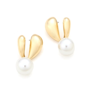 Detailed macro view of rabbit ear gold earrings featuring large polished white pearls