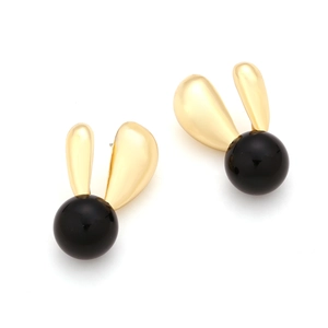 Detail of minimalist black resin rabbit stud earrings with gold finish bunny ears