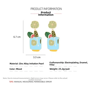 Detail view of tropical cocktail earrings with blue enamel and lime charms (6.7x3.3cm)