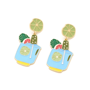 Detailed close-up of summer cocktail enamel earrings with tropical fruit and leaf charms