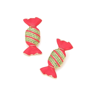 Close-up of candy-shaped red enamel earrings with green rhinestone details and gold base