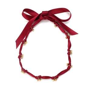 Double-layered beaded necklace featuring red satin bows and gold bell accents
