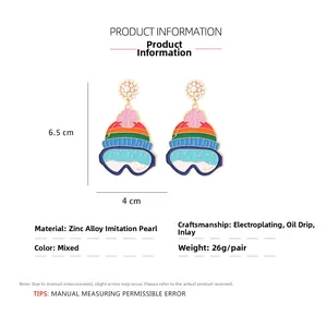 Detail of colorful ski hat drop earrings with faux pearls and enamel finish on zinc alloy