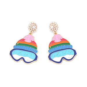 Macro detail of skiing hat earrings featuring faux pearls and colorful enamel goggles