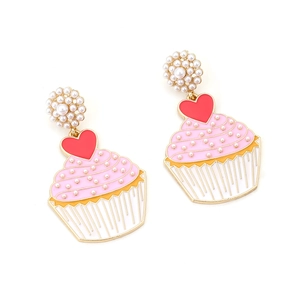 Enamel cupcake earrings with pink frosting, red heart, and pearls on a gold base