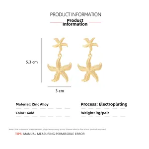 Detailed view of gold starfish drop earrings with size measurements of 5.3cm x 3cm