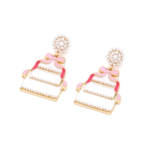 Sweet enamel cake drop earrings with pearls and pink ribbons on white background