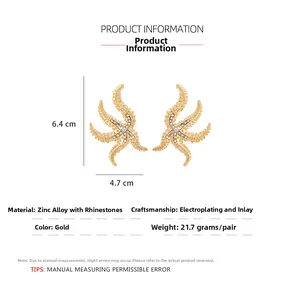 Detailed size view of luxury gold starfish earrings with sparkling white rhinestones