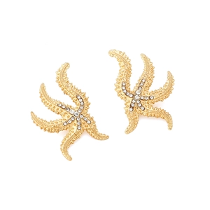 Exaggerated golden starfish stud earrings with sparkling crystals and textured finish