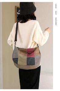 Detail of color-block cowhide canvas bag showing patchwork leather textures and strap hooks