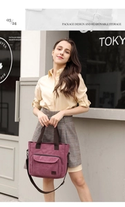 Detail of plum canvas tote bag showing large front zipper pocket and logo branding