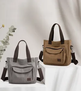 Detail of high-capacity canvas tote bags with front pockets and adjustable straps