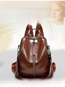 Brown faux leather backpack with vertical zip and striped woven shoulder strap detail
