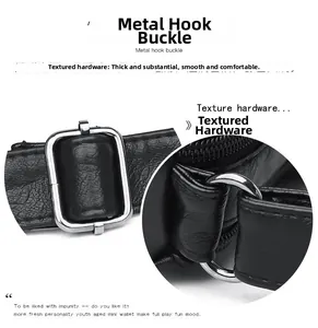 Detail of silver metallic buckle and circular ring on black pebbled leather crossbody bag