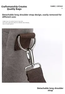 Detail of detachable brown strap with silver rotating metal hook on gray canvas bag