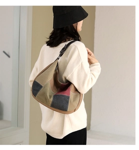 Detailed back view of a large multi-color patchwork canvas tote bag on a model shoulder