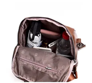 Interior view of brown leather backpack showing large capacity and rose pattern lining