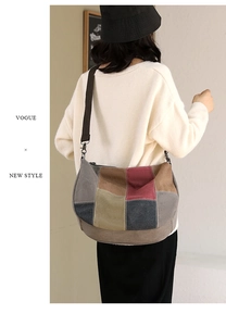 Detailed close-up of a large multi-color canvas tote bag showing stitching and wide strap
