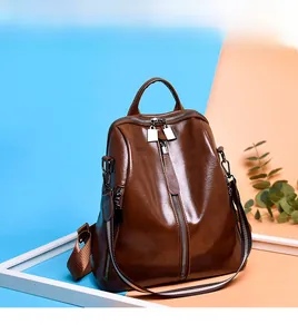 Brown vintage faux leather backpack with vertical zippers and colorful fabric shoulder straps