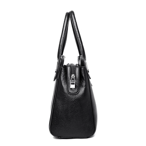 Classic black leather handbag with side view, top handles and silver zipper detail