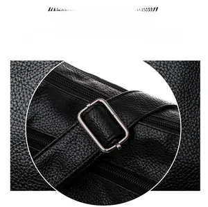 Detail of black lychee grain leather bag with silver metal buckle and stitching