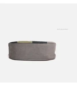 Detail view of the reinforced canvas bag bottom with gray and green color-block design