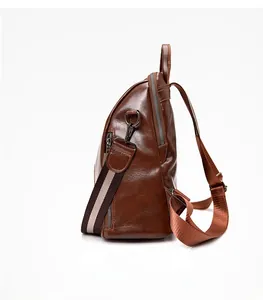 Side view of dark brown vintage soft leather backpack with silver zippers and canvas strap