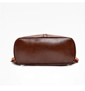Detail view of the vintage brown leather backpack base with premium stitching