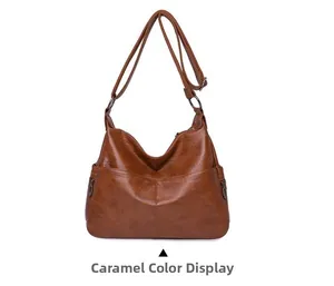 Detailed view of caramel PU leather hobo bag with topstitching and metal zipper