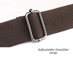 Detail of adjustable thick brown canvas strap with silver stainless steel buckle