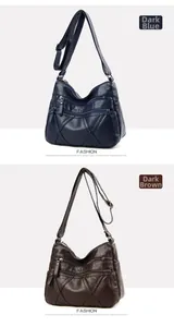 Close-up of soft PU leather shoulder bags in dark blue and dark brown with multi-zippers