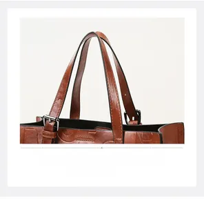 Gros plan du cabas vintage en cuir marron montrant les coutures et les boucles