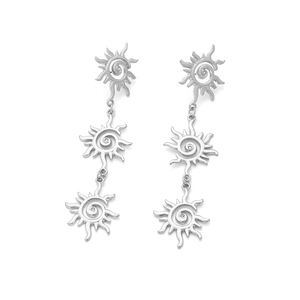 Detail of bohemian silver sun earrings with layered geometric rotating flower patterns