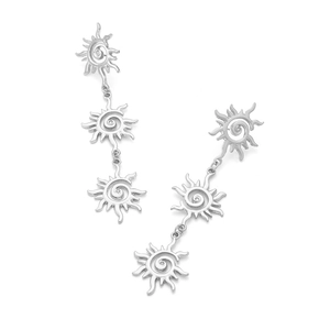 Close-up of triple layered silver sunburst earrings with detailed spiral textures