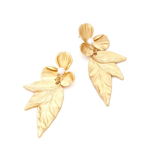 Detail of matte gold fan-shaped leaf earrings with centered white faux pearl accents