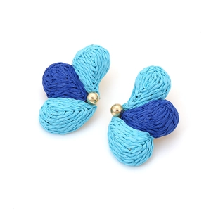 Detailed texture of blue raffia woven leaf earrings with a golden bead center accent