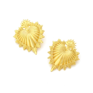 Vintage gold heart earrings with textured ray pattern in sacred heart style on white background