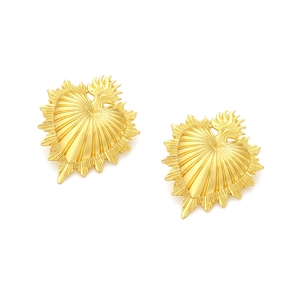Vintage textured golden heart earrings with radiant flame design on a white background