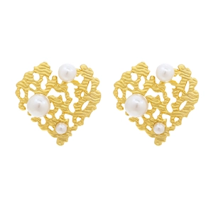 Vintage textured gold heart earrings with faux pearl embellishments on white background