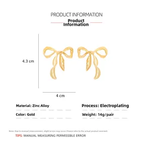 Detailed specs of oversized golden bow earrings made of zinc alloy with plating