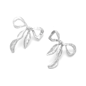 Minimalist silver bow earrings with vintage hammered texture on a clean white background