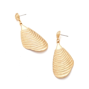 Detailed macro view of golden geometric earrings featuring a textured wavy shell-like design