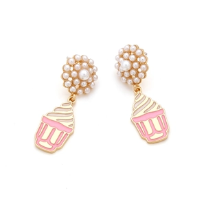 Detail of cute cupcake dangle earrings with pink enamel and white pearls on gold base