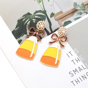 Cute enamel candy corn drop earrings with white pearl flower studs and red bows