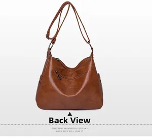 Back view of brown PU leather hobo bag with adjustable strap and textured finish