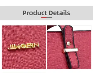 Detailed macro view of red Saffiano faux leather texture and golden metal logo hardware