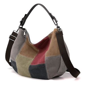 Multicolor patchwork canvas hobo bag with adjustable brown strap and leather handle