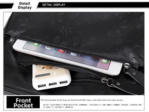 Detailed view of the front zipper pocket on a floral embossed black leather handbag