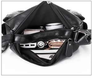 Top view showing the spacious interior compartments of this black embossed leather handbag