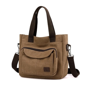 Brown canvas tote bag with large front zipper pocket and adjustable shoulder strap
